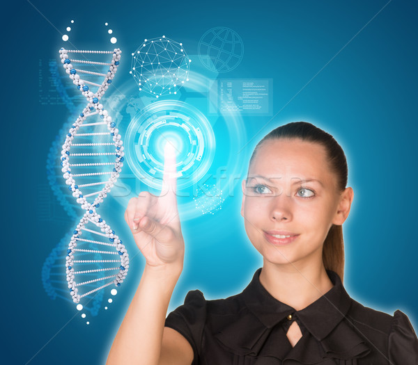 Beautiful young girl looks at model of DNA and presses her finger Stock photo © cherezoff
