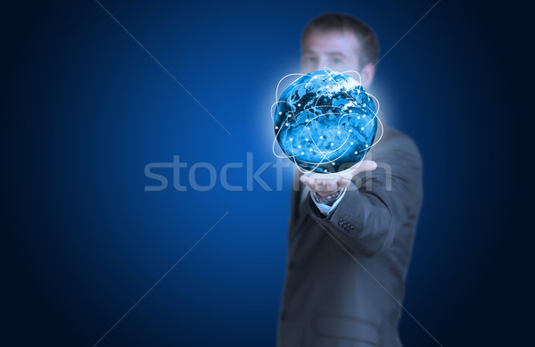 Stock photo: Businessman with Earth and glowing lines