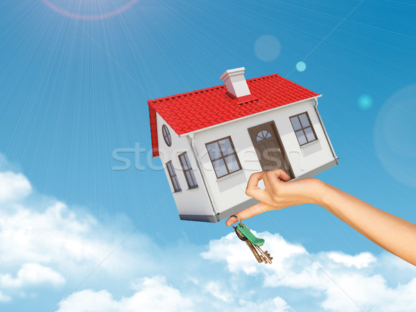 House and keys in womans left hand under clouds Stock photo © cherezoff