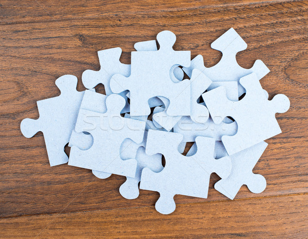 Pile of puzzle pieces on table. Stock photo © cherezoff