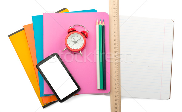 Crayons on copybooks with smartphone Stock photo © cherezoff