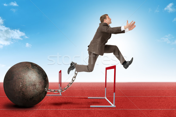 Businessman jumping over barrier Stock photo © cherezoff