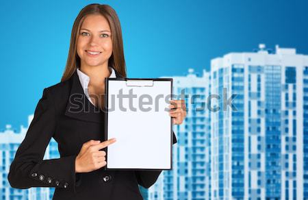 Businesswoman holding paper sheet Stock photo © cherezoff