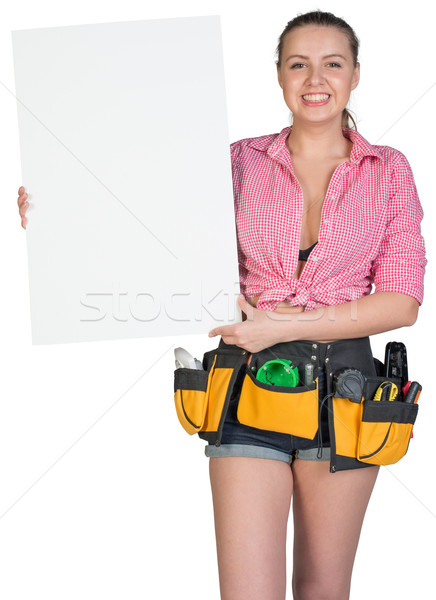 Woman in tool belt showing blank banner Stock photo © cherezoff