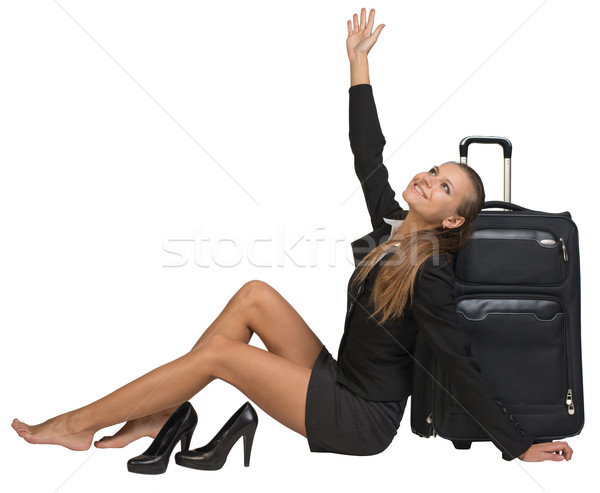 Businesswoman with her shoes off sitting next to front view suitcase Stock photo © cherezoff