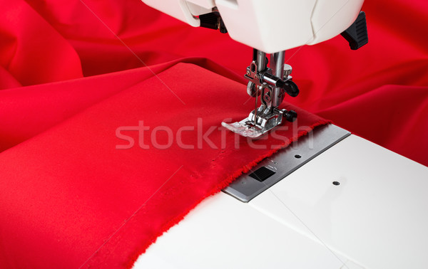 Stock photo: Sewing machine and red fabric isolated on white