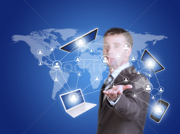 Business man hold tablet pc, smartphone and laptop in hand Stock photo © cherezoff