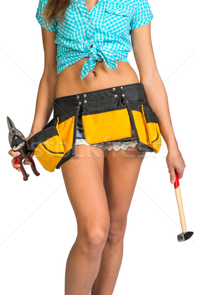 Woman wearing shirt, shorts and tool belt, holding hammer Stock photo © cherezoff
