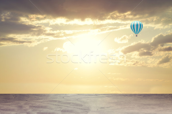 Evening sunset. Concrete floor on background of clouds, sun with air balloon Stock photo © cherezoff