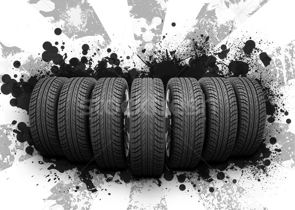 Wedge of new car wheels. Black blotches and gray stripes Stock photo © cherezoff