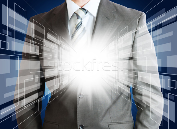 Businessman with glowing abstract background Stock photo © cherezoff