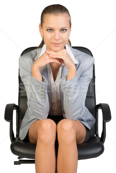Businesswoman on office chair, with head reclined upon her hands Stock photo © cherezoff