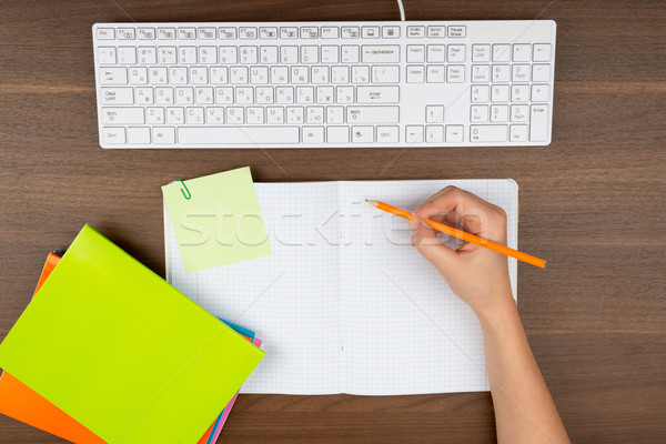 Humans hand writing in copy book Stock photo © cherezoff