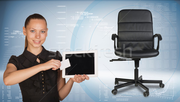 Businesswoman holding tablet PC and business card. Office chair beside Stock photo © cherezoff