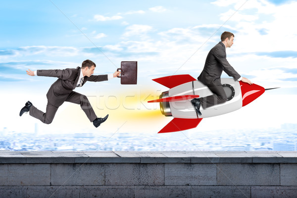 Running businessman following man flying on rocket Stock photo © cherezoff