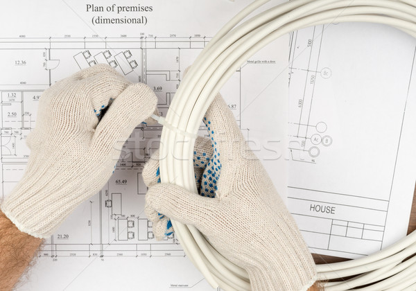 Mans handsin gloves holding wires Stock photo © cherezoff