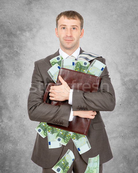 Businessman holding suitcase with piles of euro Stock photo © cherezoff