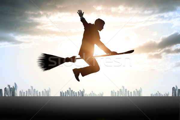Businessman flying on broom Stock photo © cherezoff