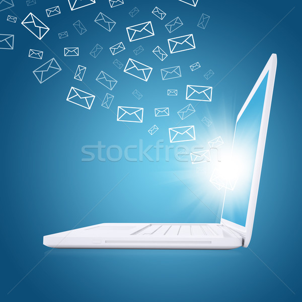 Emails fly out of laptop screen Stock photo © cherezoff
