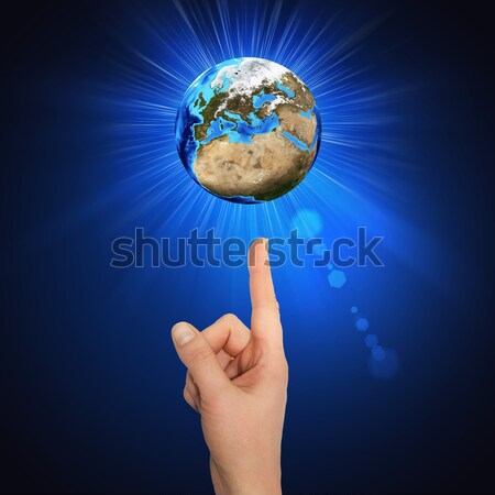 Hand goes to the planet Earth Stock photo © cherezoff