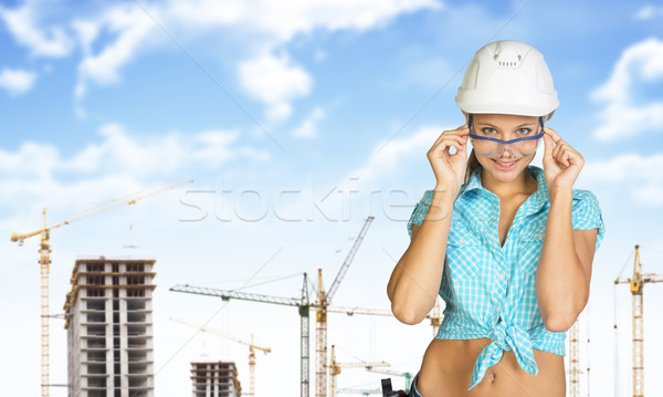 Woman in hard hat adjusting protective glasses Stock photo © cherezoff