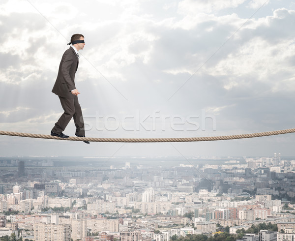 Stock photo: Man with closed eyes softly walking on rope