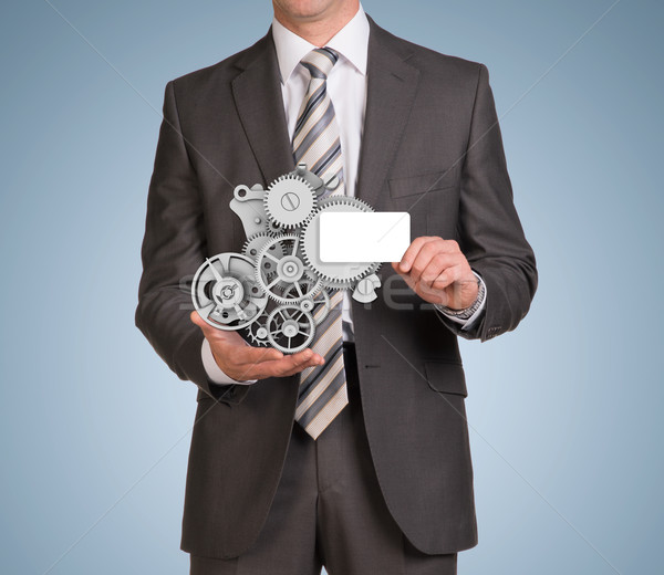 Businessman hold empty card and clockwork Stock photo © cherezoff