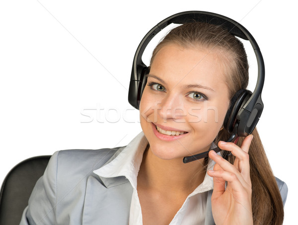 Businesswoman in headset, with her fingers on microphone boom Stock photo © cherezoff