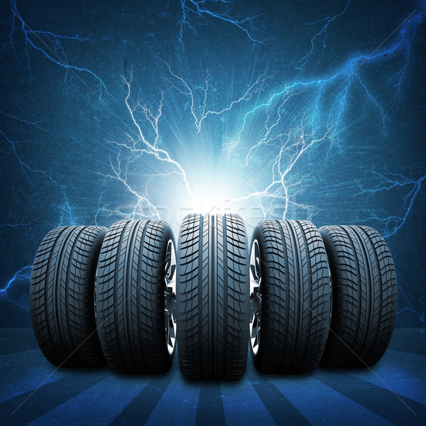 Five of new car wheels. Concrete wall, lightning and stripes  Stock photo © cherezoff
