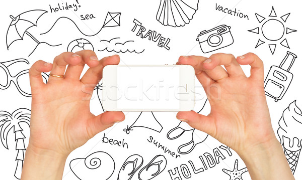 Hands holding a smartphone. Around summer sketches Stock photo © cherezoff