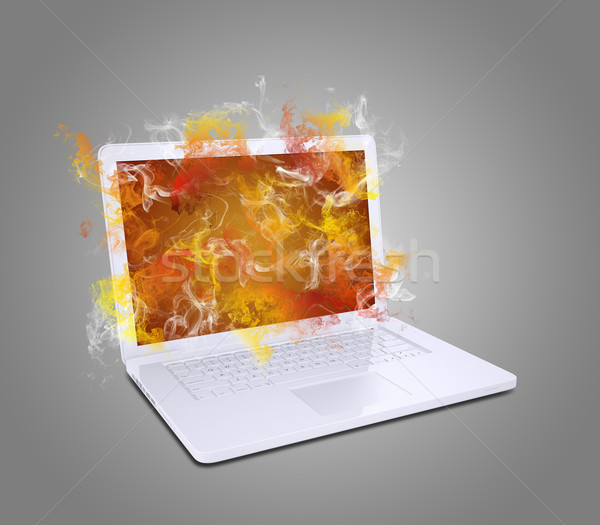 Stock photo: Open white laptop emits colored smoke