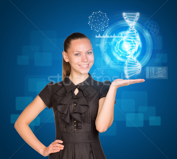 Beautiful businesswoman in dress smiling and holding model of DNA Stock photo © cherezoff