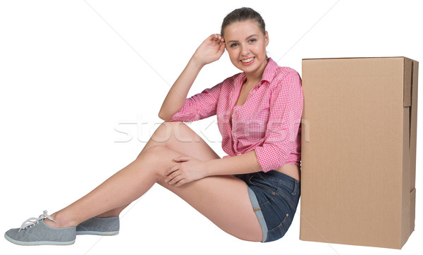 Woman sitting next to cardboard box Stock photo © cherezoff