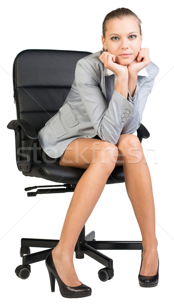 Businesswoman on office chair with head reclined upon her hands Stock photo © cherezoff