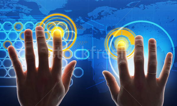 Hands touching blue holographic screen Stock photo © cherezoff