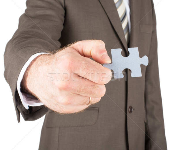 Businessman holding puzzle piece Stock photo © cherezoff