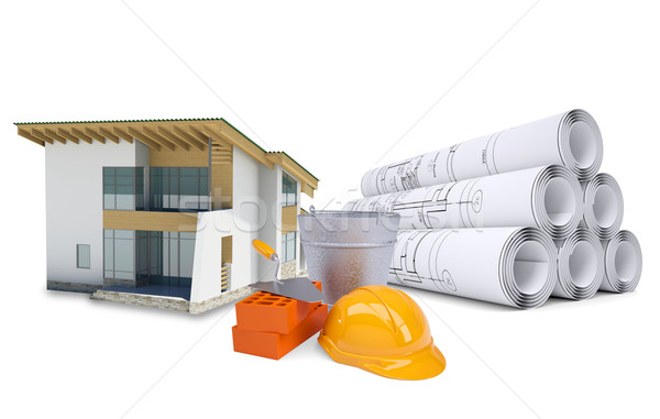 Small model house near scrolls of architectural drawings and work tools Stock photo © cherezoff
