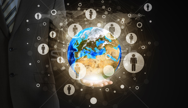 Businessman hold Earth and contacts Stock photo © cherezoff