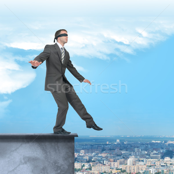 Stock photo: Businessman walking from edge of building roof