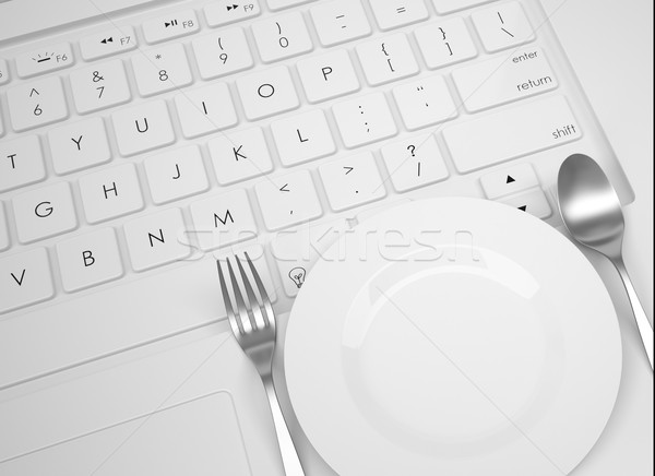 Plate, spoon and fork on the keyboard Stock photo © cherezoff
