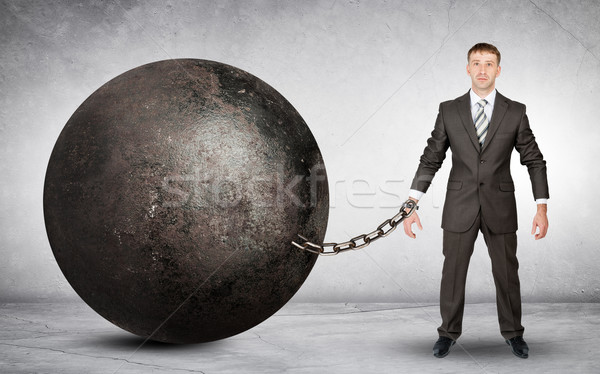 Businessman chained to large ball Stock photo © cherezoff