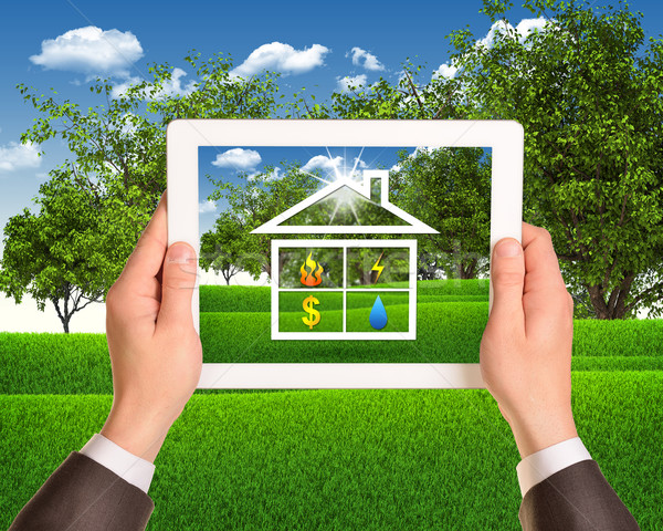 Hands hold tablet with symbols of public service and house Stock photo © cherezoff