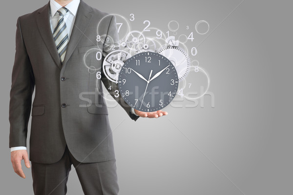 Businessman hold clock Stock photo © cherezoff