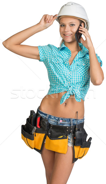 Woman in hard hat and tool belt calling on mobile phone Stock photo © cherezoff