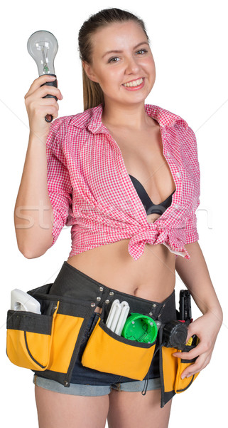Woman in tool belt holding lamp bulb Stock photo © cherezoff