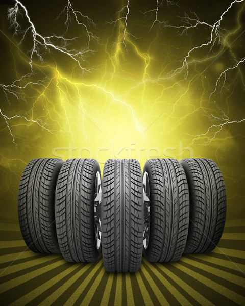 Wedge of new car wheels. Yellow background with lightning and stripes at bottom Stock photo © cherezoff