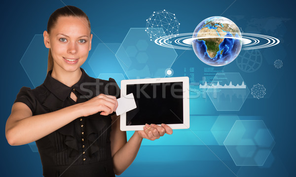 Stock photo: Businesswoman holging tablet and Earth model