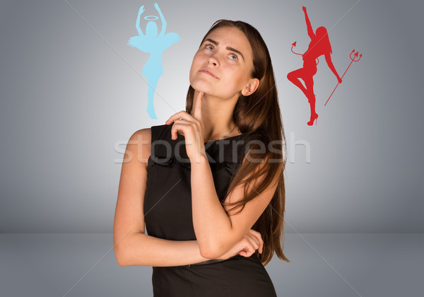 Woman musing between angelic and devilish figures  Stock photo © cherezoff