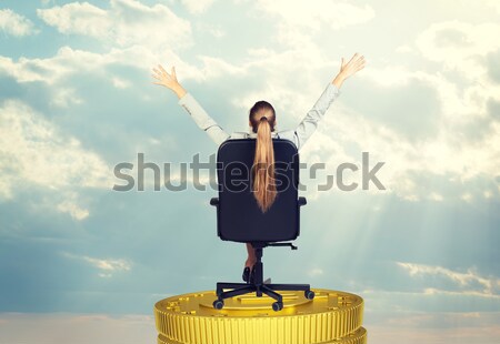 Businesswoman sitting on office chair her arms extended Stock photo © cherezoff
