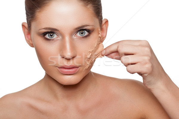 woman taking off her skin from face Stock photo © chesterf